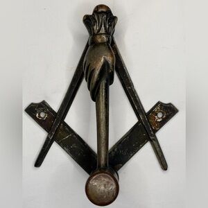 Antique bronze Masonic door knocker square and compasses hand holding a gavel.